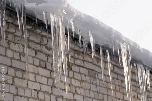 Long icicles at an old house . photo