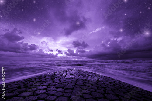 Ultra violet fantasy background, road to the ocean with fantastic night sky, color of the year 2018 photo