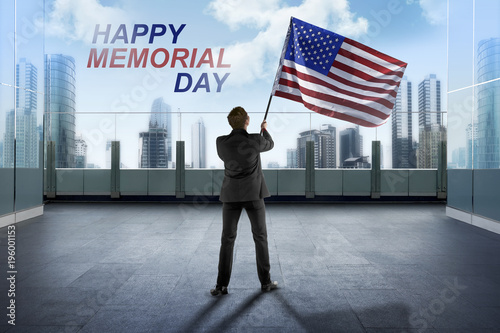 Businessman waving American flag for happy memorial day