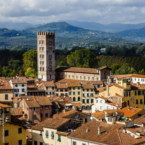 View of San Frediano Basilica belfry from top of Guinigi Tower. Location Lucca, Tuscany, Italy. Picturesque travel panoramic city overview travel postcard.