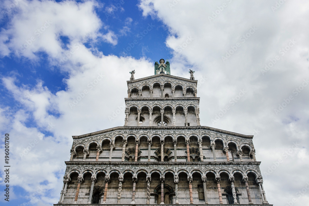 Top of St Michael Church (Chiesa di San Michele in Foro) decorated facade, Lucca, Tuscany, Italy.