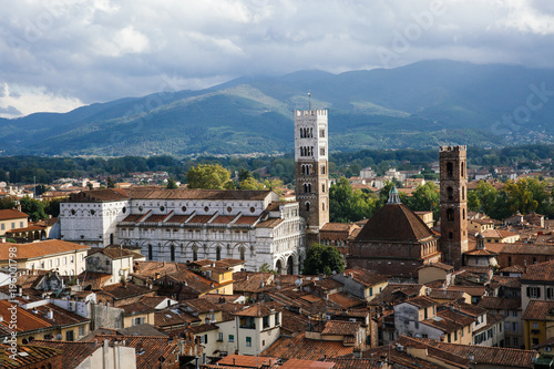 Scenic view of St. Martin Cathedral (Chiesa di San Martino) with bell tower from Torre delle Ore. Location Lucca, Tuscany, Italy. Picturesque travel postcard. © mykolastock
