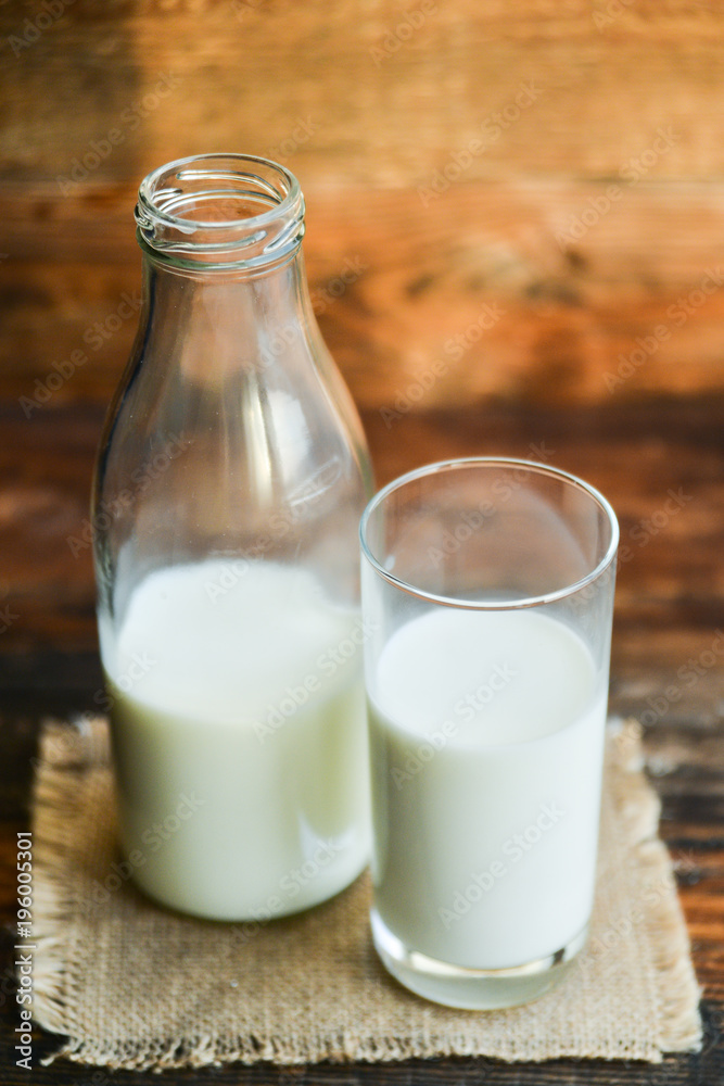 glass of milk, cow on natural wooden background in rustic style, rural style, concept of natural products and farming glass of milk, cow on natural wooden background in rustic style, rural style, concept of natural products and farming