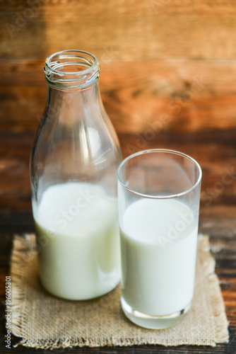 glass of milk  cow on natural wooden background in rustic style  rural style  concept of natural products and farming