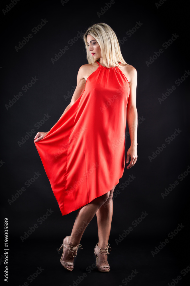 beautiful girl in red dress in studio