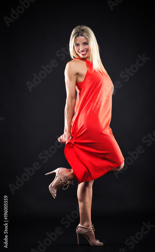 beautiful girl in red dress in studio