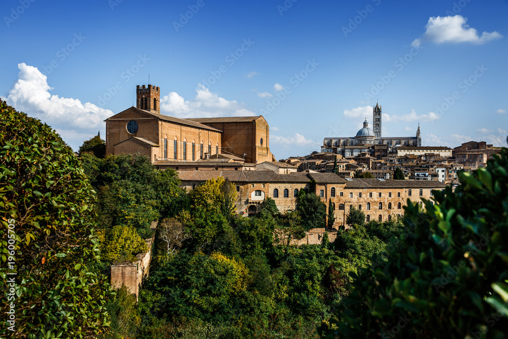 Scenic panorama of Siena old city center on bright autumn day, Tuscany, Italy.  View of Cathedral Santa Maria Assunta (Duomo). Picturesque italian cityscape travel destination postcard.
