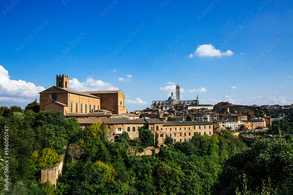 Scenic panorama of Siena old city center on bright autumn day, Tuscany, Italy. Scenery of beautiful ancient medieval town. View of Siena Cathedral Santa Maria Assunta (Duomo).