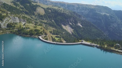 Artificial lake and dam - barrage sur lac artifiel. Tseuzier, Switzerland - cinematic aerial shot photo