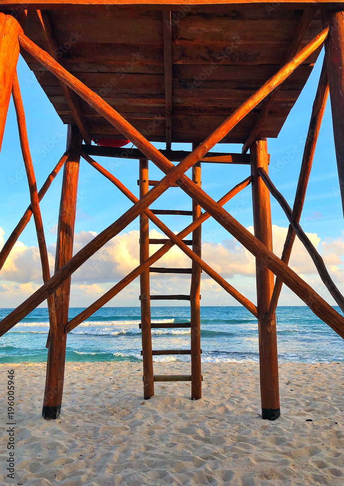 Wooden watchtower on the empty beach at sunset, Cancun, Mexico Wooden watchtower on the empty beach at sunset, Cancun, Mexico