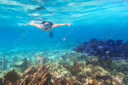 Young woman snorkeling in the tropical water of Mexico