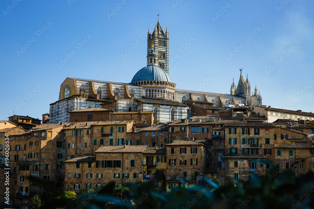 Scenic panorama of Siena, Tuscany, Italy. Scenery of beautiful ancient medieval town. View of Siena Cathedral Santa Maria Assunta (Duomo). Picturesque italian cityscape travel destination postcard.