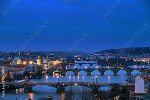 Panorama of the old part of Prague from the Letna park at dusk. Beautiful view on the bridges over the river Vltava after sunset. Old Town architecture, Czech Republic.