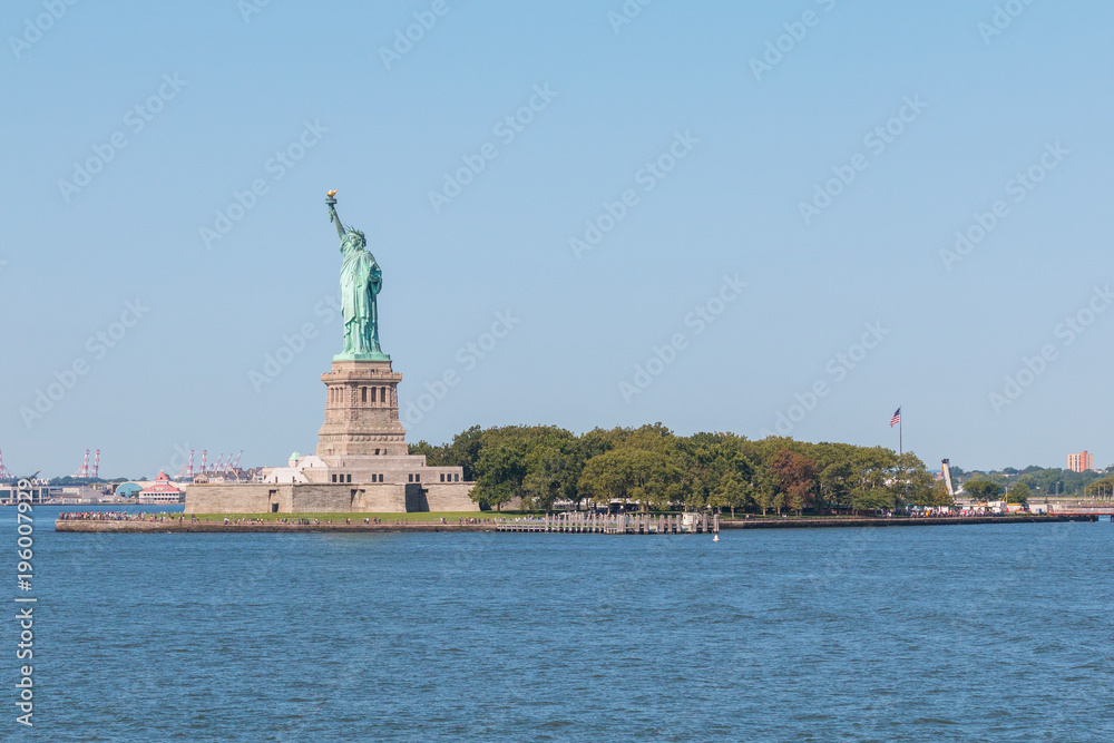 Statue of Liberty and panoramic view of Manhattan City skyline.