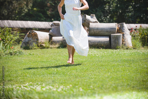 Barefooted Bride Running on Grass