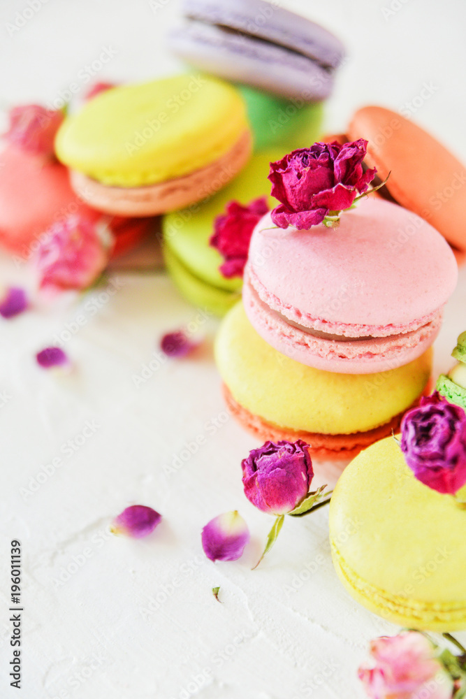 Delicate French Macaroons With Fresh Flowers Roses On Light Background