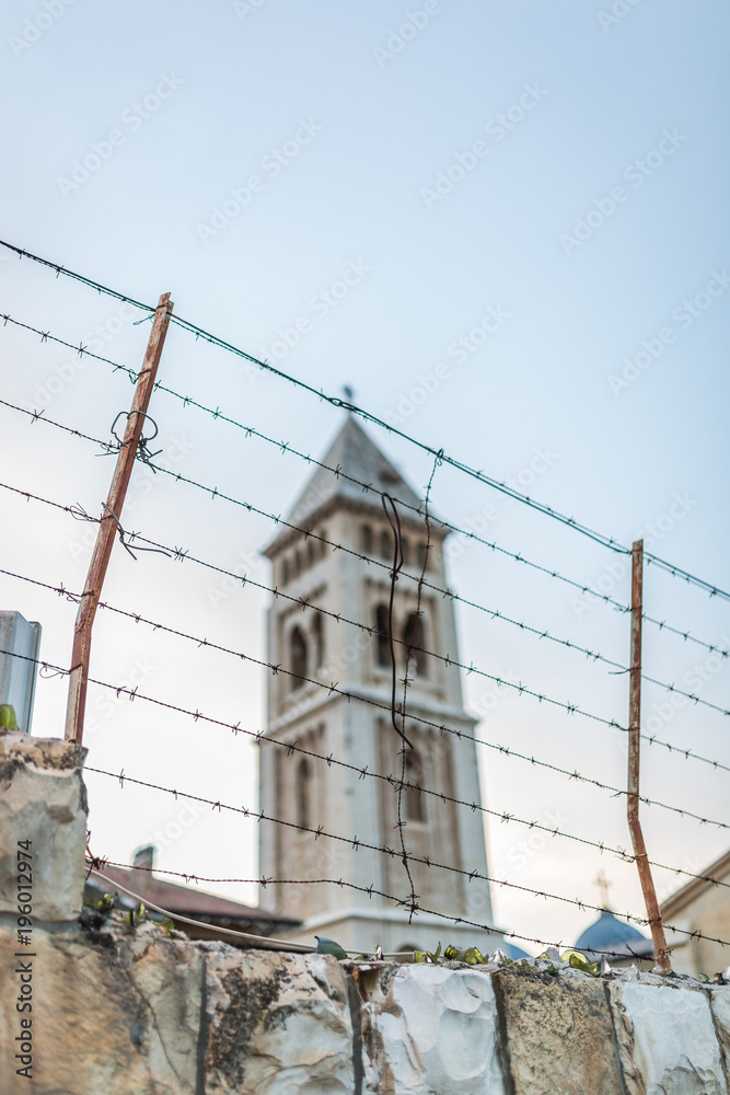 church tower behind barbed wire in Jerusalem, Israel church tower behind barbed wire in Jerusalem, Israel