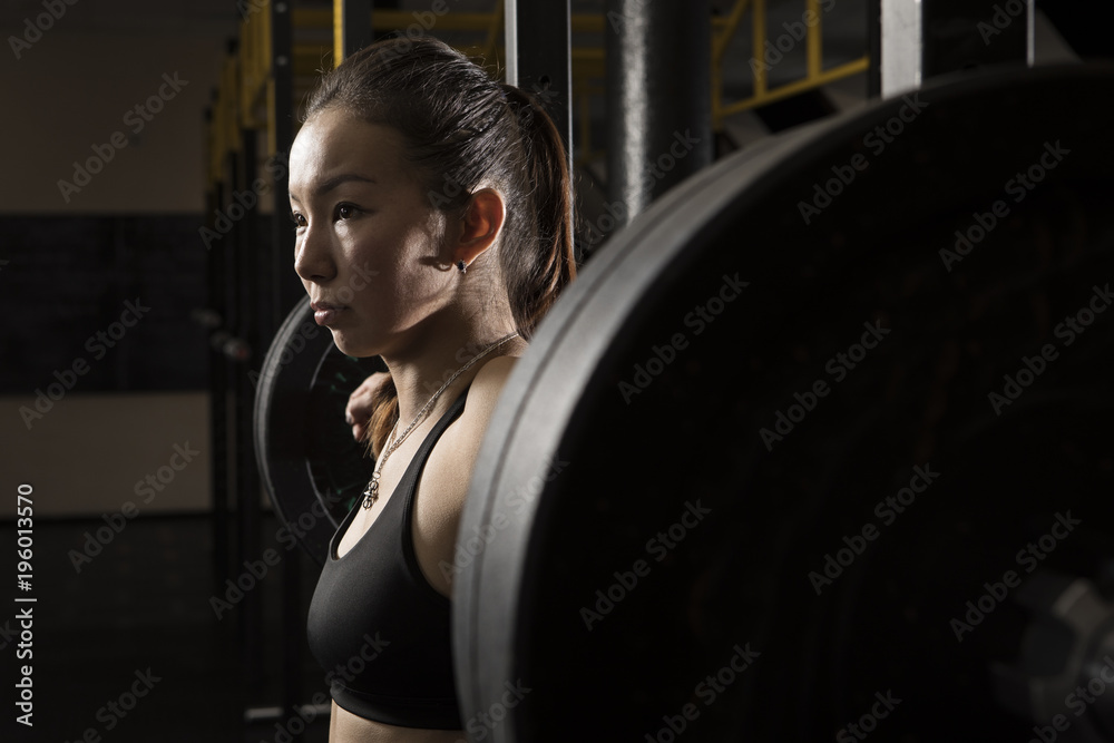 Woman workout with barbell at gym. Crossfit style Woman workout with barbell at gym. Crossfit style