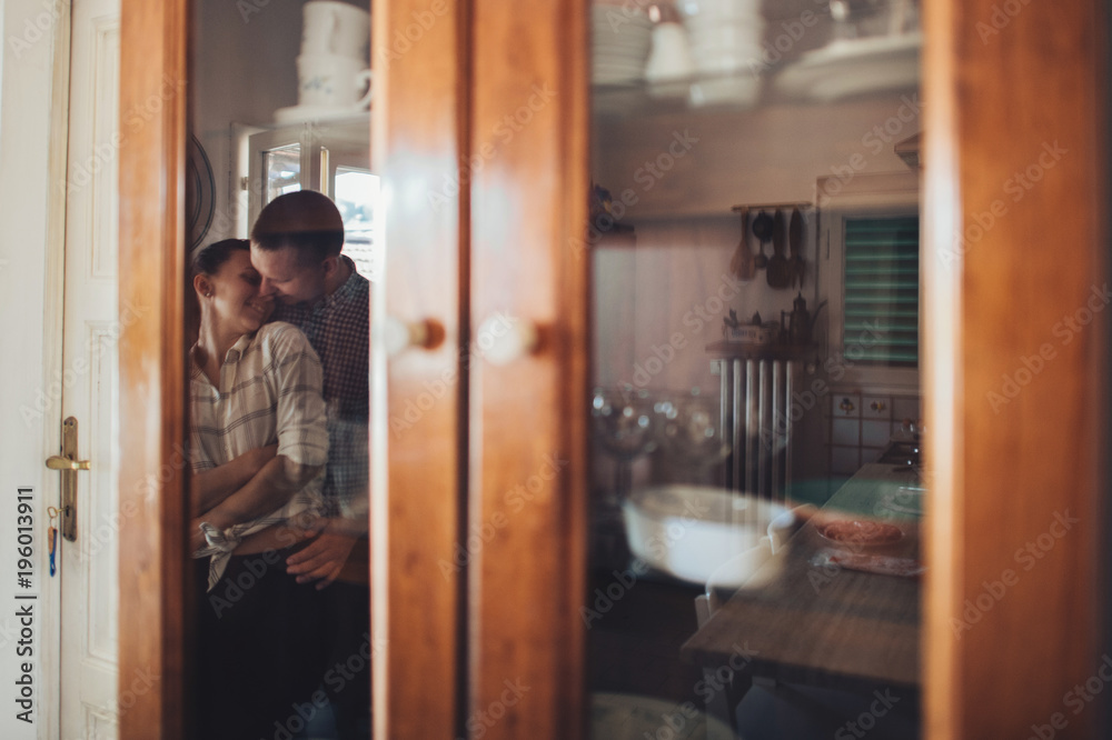 Romantic couple in love spending time together in kitchen