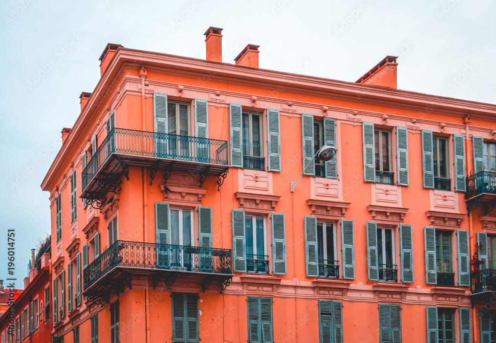 Fototapeta premium red apartment house with green windows