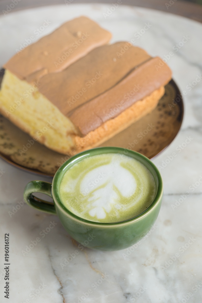 Matcha latte with butter cake breakfast on the marble background Matcha latte with butter cake breakfast on the marble background