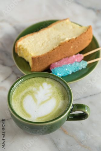 Matcha latte with butter cake breakfast on the marble background