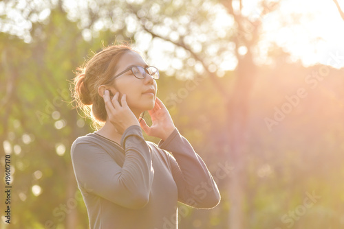 Asian woman is listening to the music.