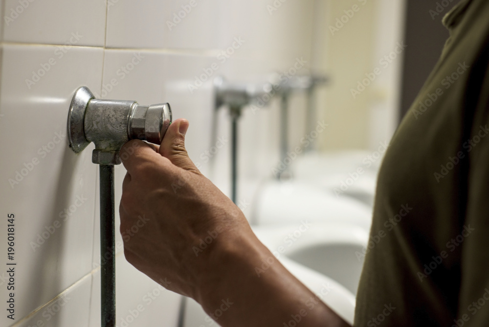 young man using a urinal in a public washroom Stock Photo Adobe Stock