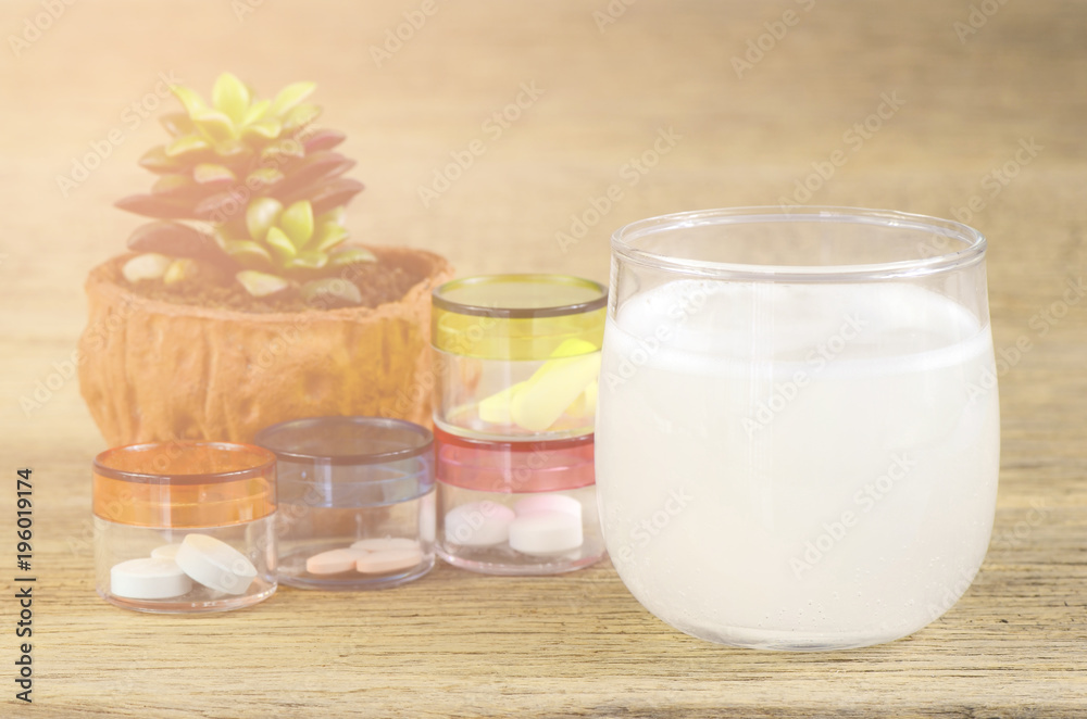 oral medication on wood background with soft light. oral medication on wood background with soft light.