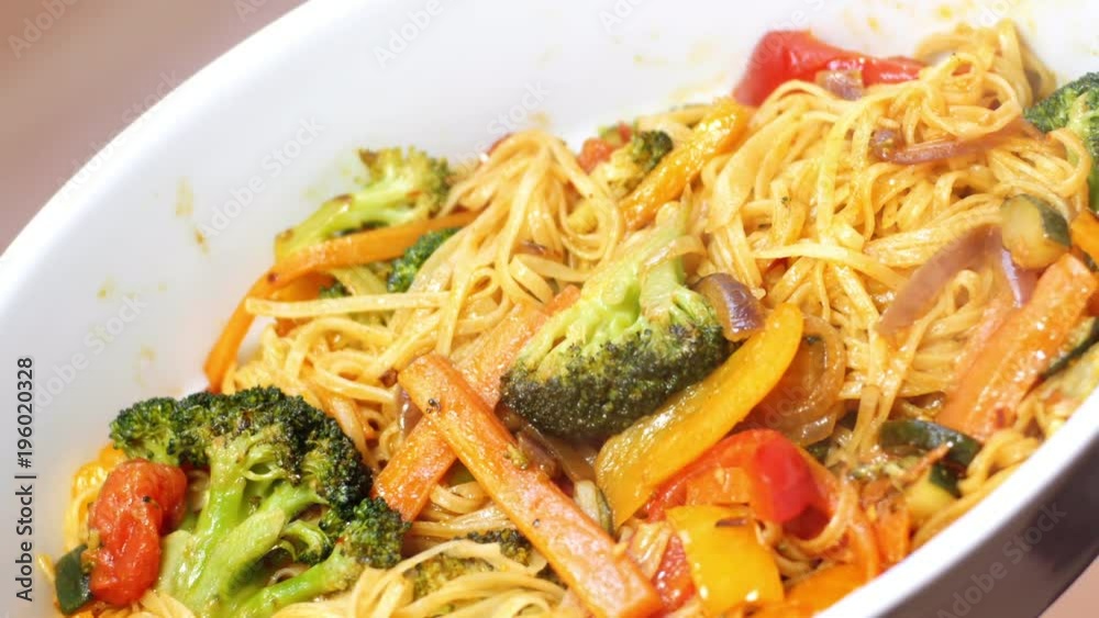 Stir fry noodles cooking on a fry pan. Chef frying vegetables with noodles, Asian food. 4K video Stir fry noodles cooking on a fry pan. Chef frying vegetables with noodles, Asian food. 4K video