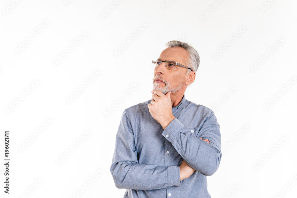 Thoughtful man looking up at copy space while standing isolated Thoughtful man looking up at copy space while standing isolated