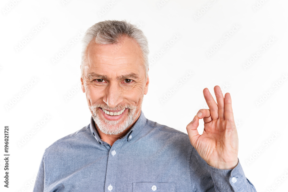 Happy man showing ok gesture and smiling isolated over white Happy man showing ok gesture and smiling isolated over white