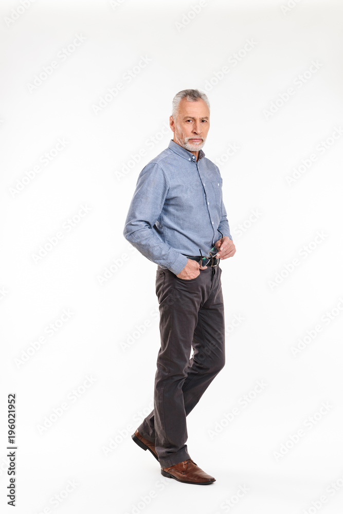 Full-length shot of old man looking camera seriously isolated Full-length shot of old man looking camera seriously isolated