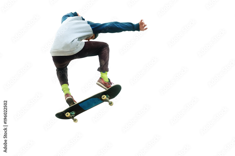 A teenager skateboarder jumps an ollie on an isolated white background. The concept of street sports and urban culture