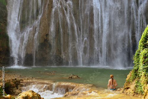 Tourist swimming in the Salto el Limon the waterfall located in the centre of the tropical forest, Samana, Dominikana Republic.