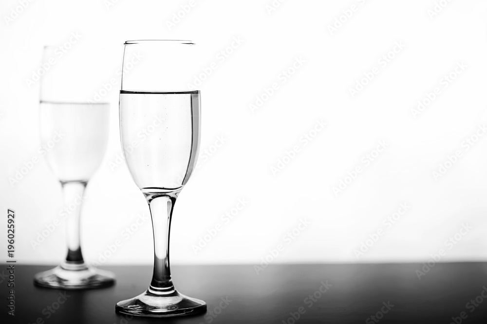 monochrome photo of champagne on white table on white background