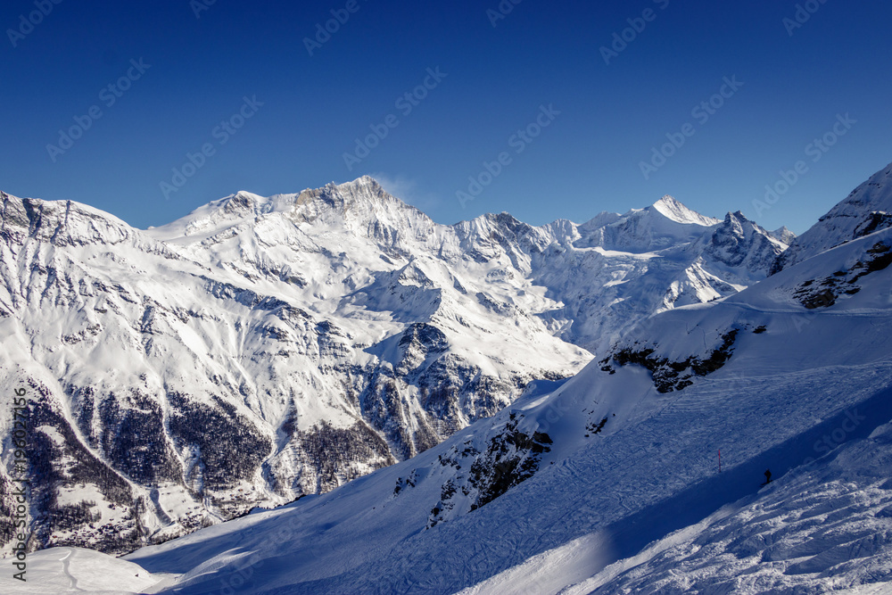 Zinal Alps panorama from Sorbois mountain station in Switzerland. The village is a typical Swiss ski resort linked with Grimentz to form a great skiing area