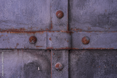 Antique metal iron surface with rivets - grunge background, texture