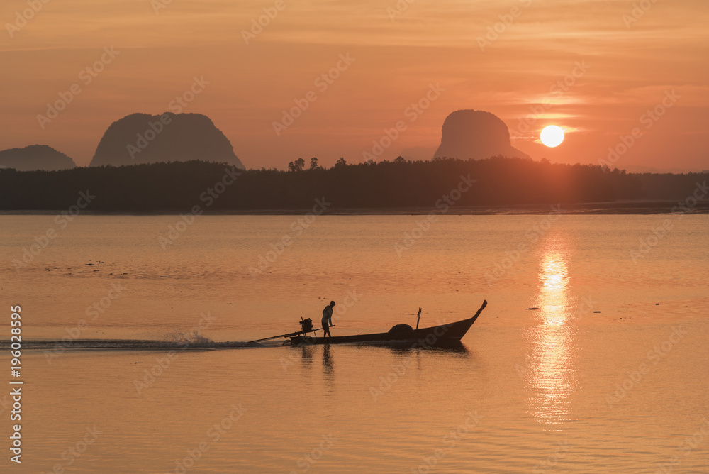 Silhouette scene of a fisherman sailing in the sea in the morning