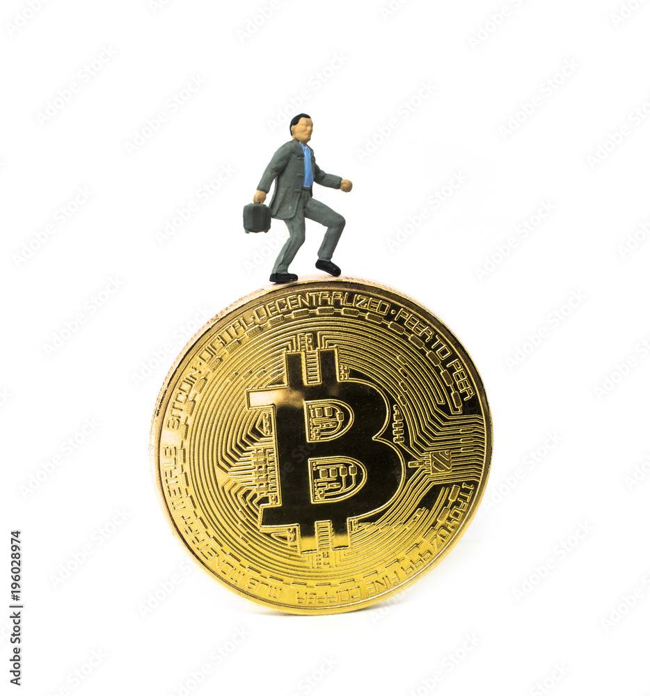 Side view of a miniature figure of businessman miner, standing on gold bitcoin. isolated on white background. Copy space Side view of a miniature figure of businessman miner, standing on gold bitcoin. isolated on white background. Copy space