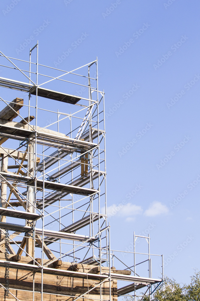 The old bell tower. Restoration of the old bell tower. Scaffolding. Old bell The old bell tower. Restoration of the old bell tower. Scaffolding. Old bell
