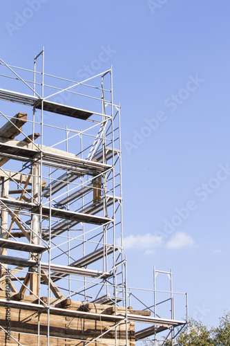 The old bell tower. Restoration of the old bell tower. Scaffolding. Old bell