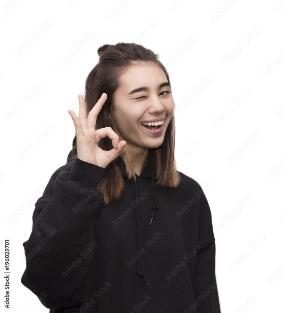 Indoor portrait of young pretty girl showing okay sign. Smiling excited woman giving OK gesture. Affirmative sign concept Indoor portrait of young pretty girl showing okay sign. Smiling excited woman giving OK gesture. Affirmative sign concept
