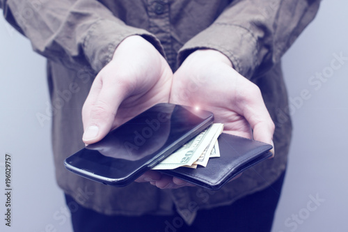 Man showing all he have in pockets: cell phone, wallet, money. Stealing, hand stealing, robbery, thief concept. Close up and toned