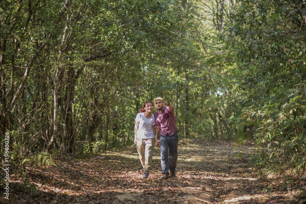 Young attractive couple hiking in the forest. Young attractive couple hiking in the forest.