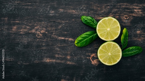 Fresh Green Lime. Fruits. On a wooden background. Top view. Copy space.