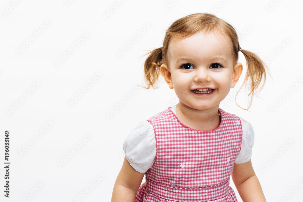Happy smiling toddler girl with ponytails isolated on white Happy smiling toddler girl with ponytails isolated on white