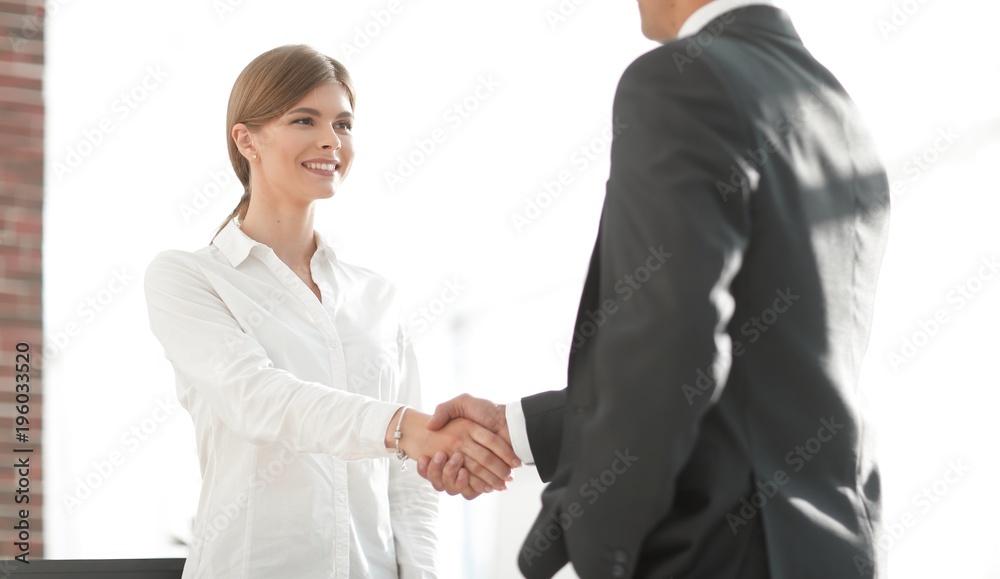 handshake young business woman with a colleague handshake young business woman with a colleague