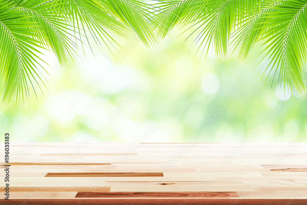 Empty wooden table with party in coconut leafs in resort garden background blurred. Empty wooden table with party in coconut leafs in resort garden background blurred.