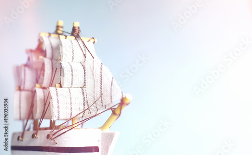 Old wooden ship with sails and masts toy on a stand. Vintage and